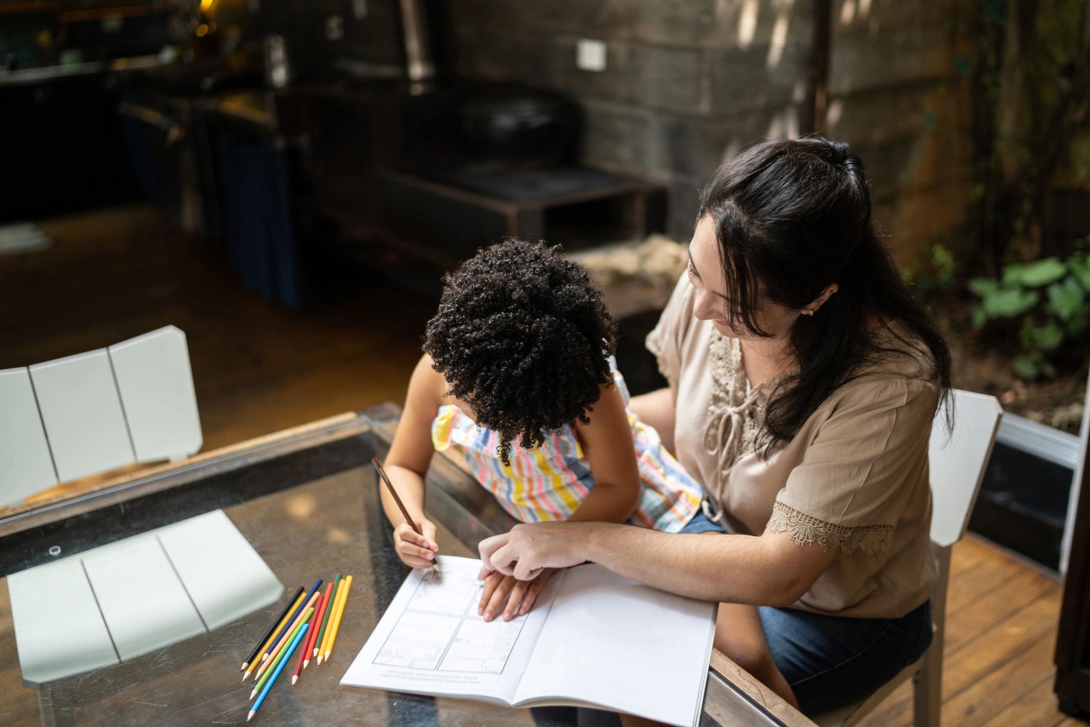 Parent and child working together at a table