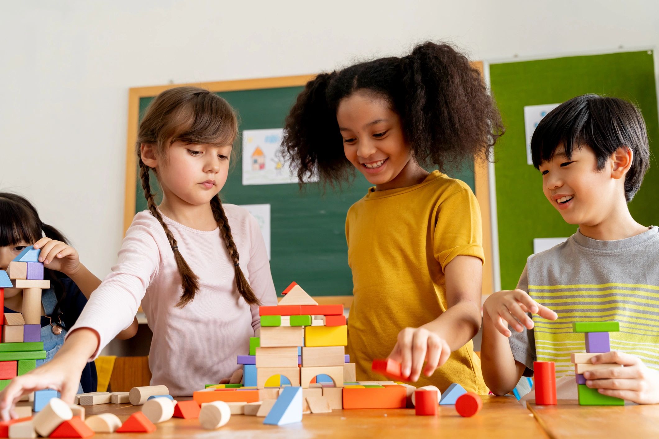 Children collaborating with wooden blocks during a classroom learning activity
