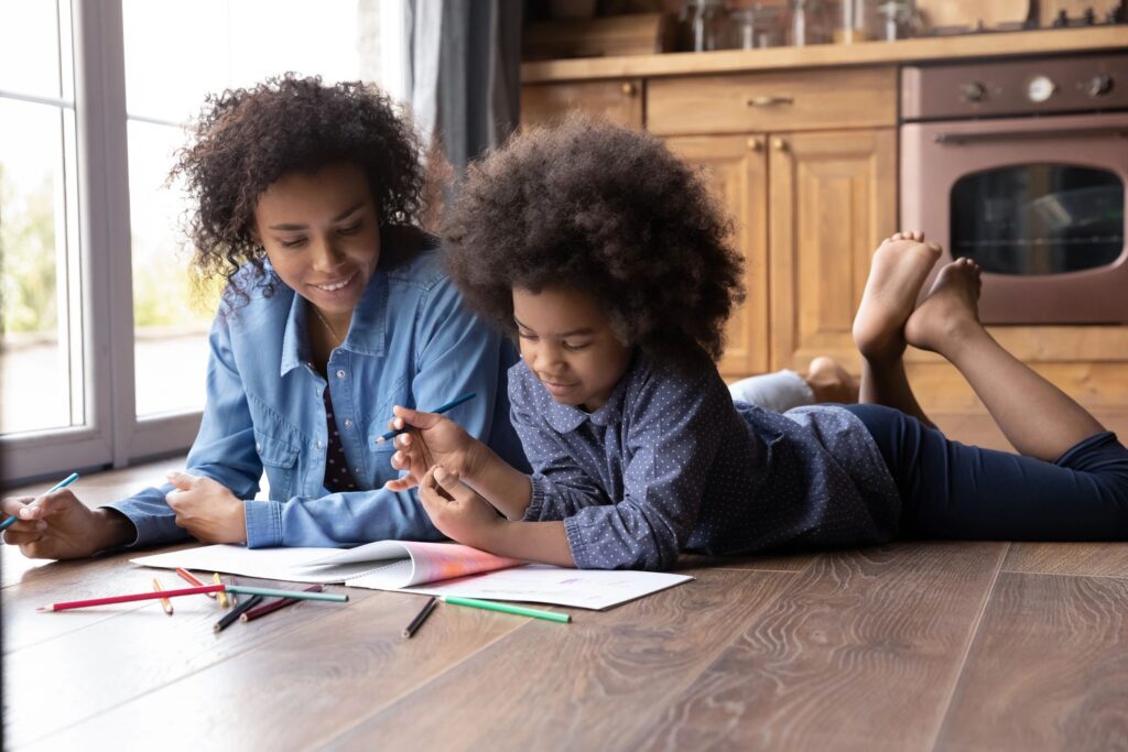 Loving ethnic mother and teen daughter painting together