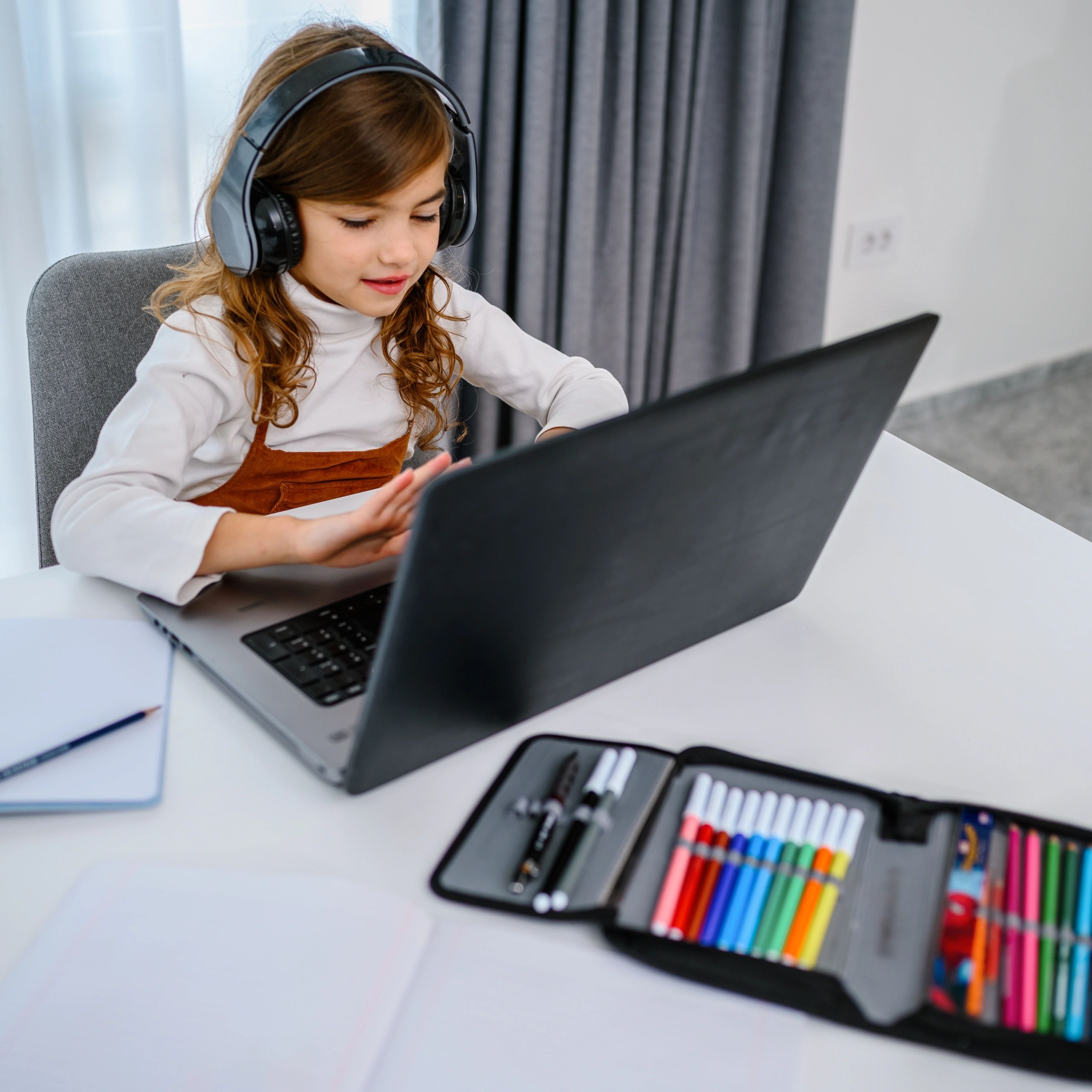 Child engaged in online learning at home