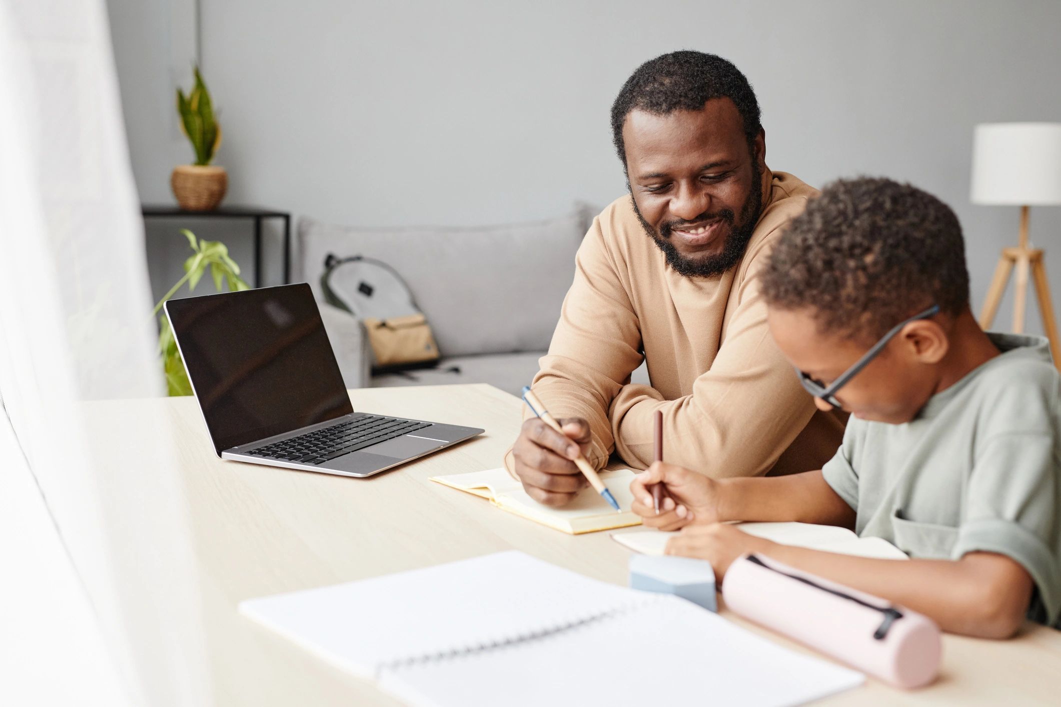 Parent helping a child review schoolwork at home