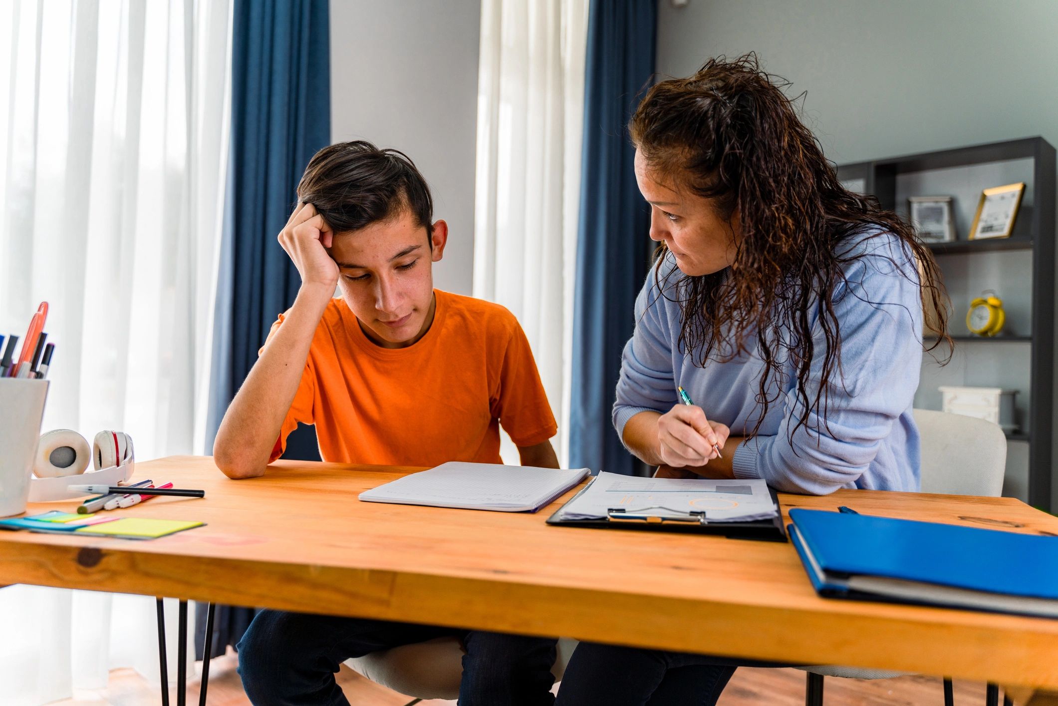 Tutor helping a young learner with homework in a calm home setting