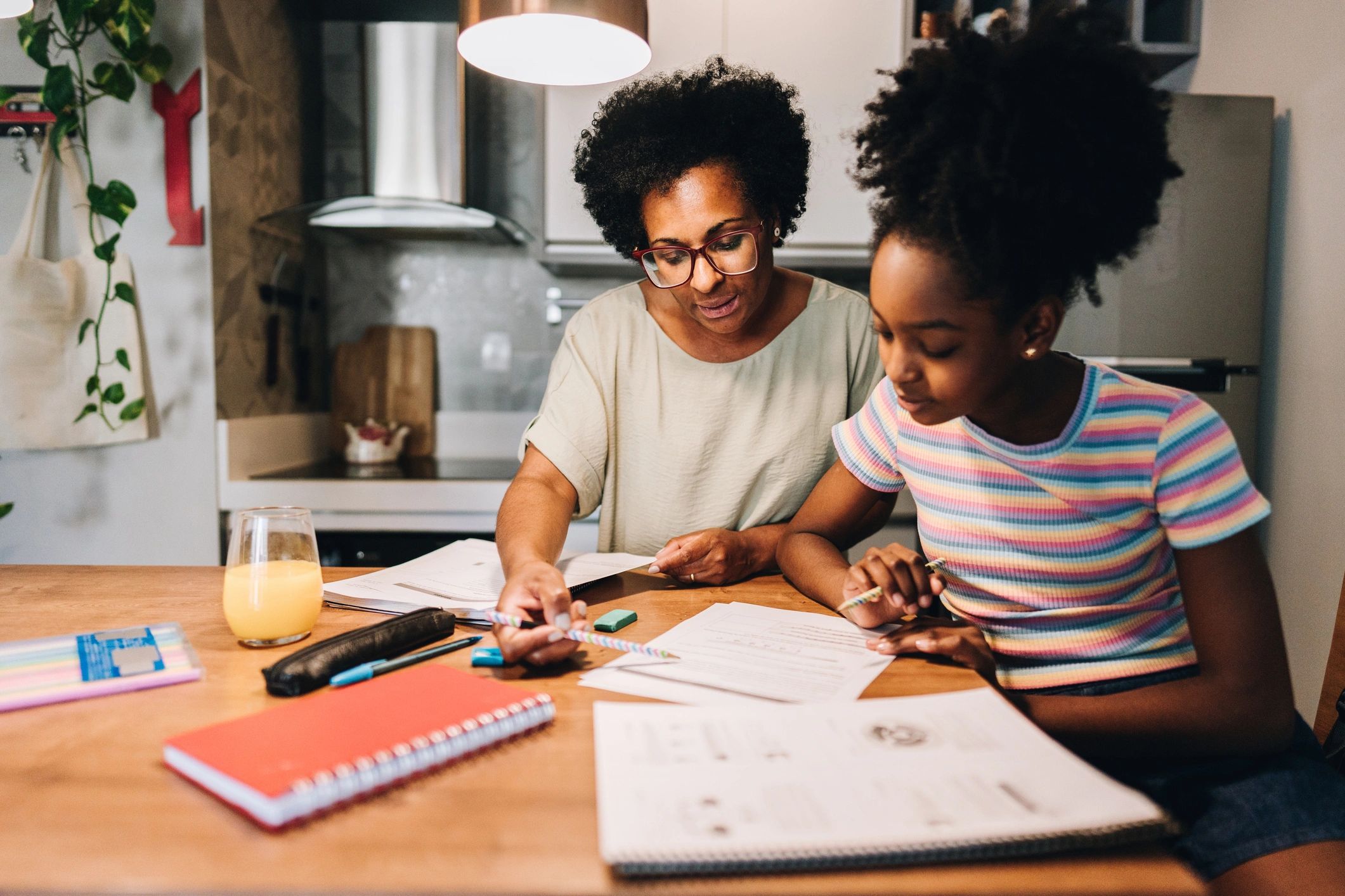 Parent supporting a child with learning at the kitchen table