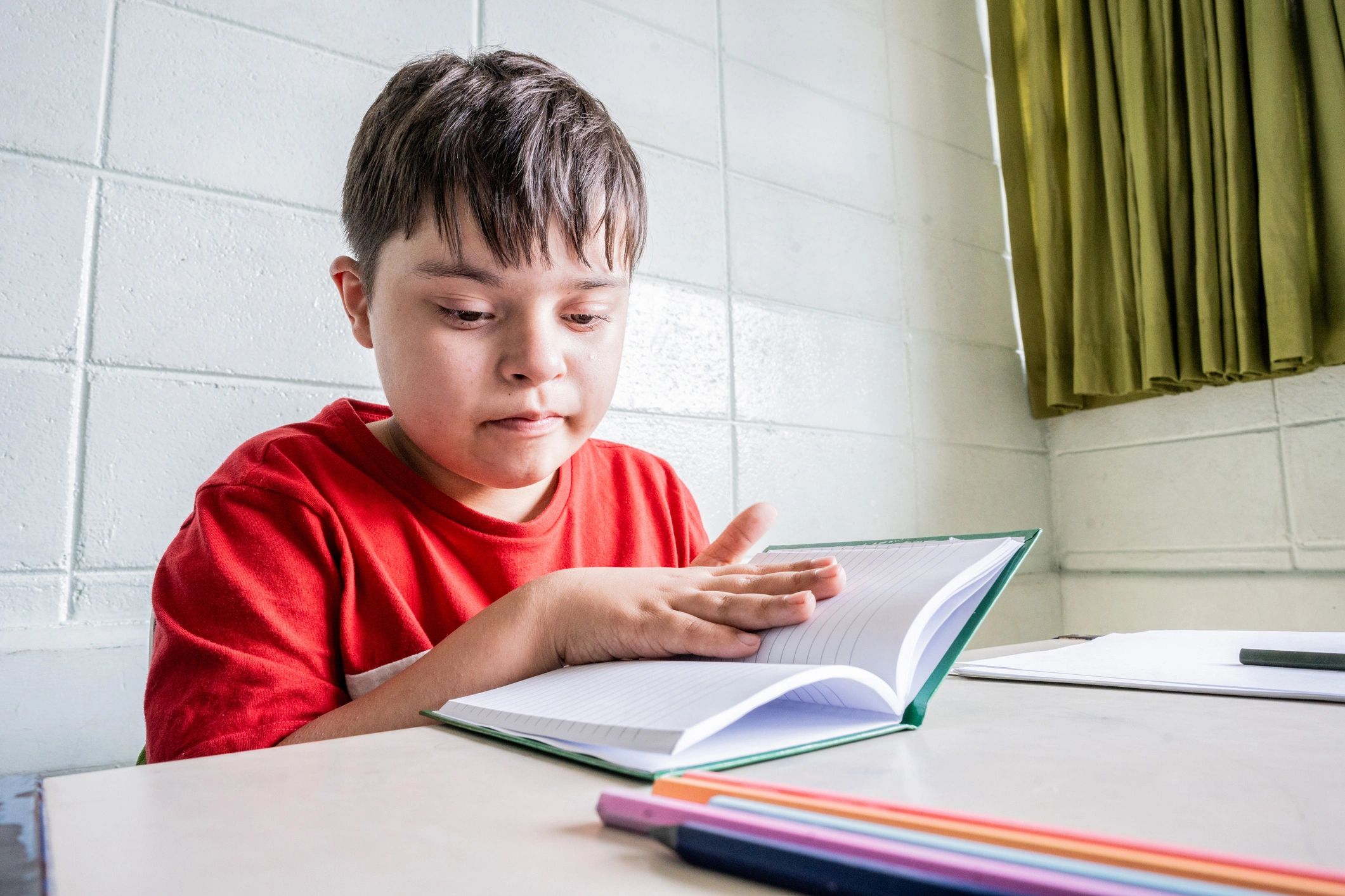 Student reading quietly in a classroom with supportive learning environment