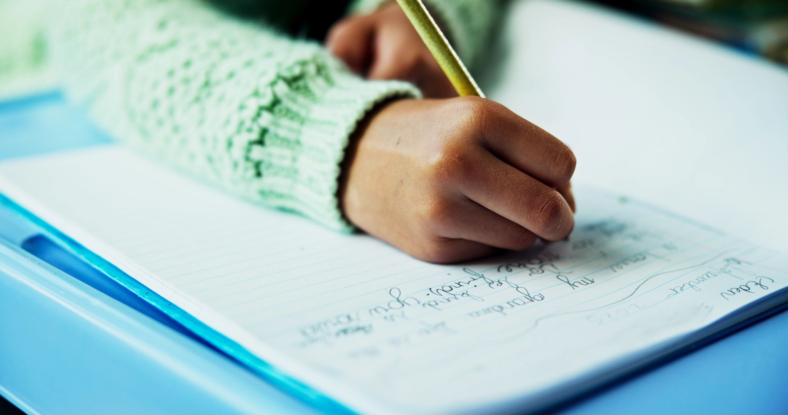 Child writing and practising literacy skills