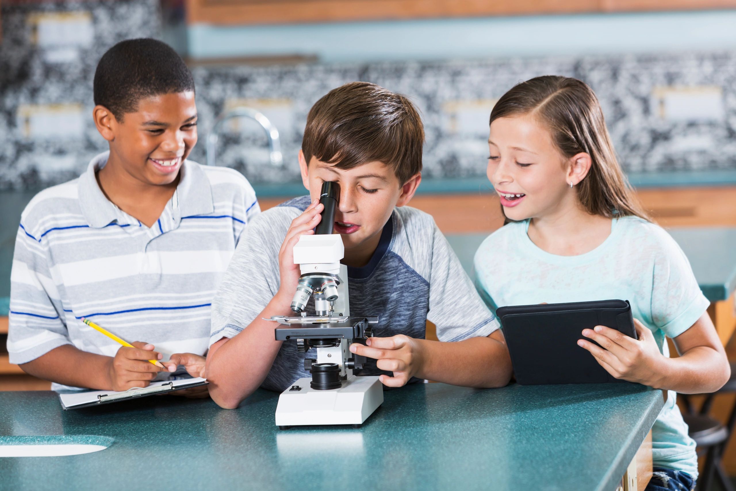 Children using a microscope in a science class